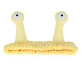 Diadema Molain Palma-Caracol en frente, cómoda para lavado facial.