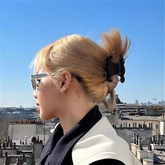 Acetate butterfly clip in peach pink adding color to a stylish bun