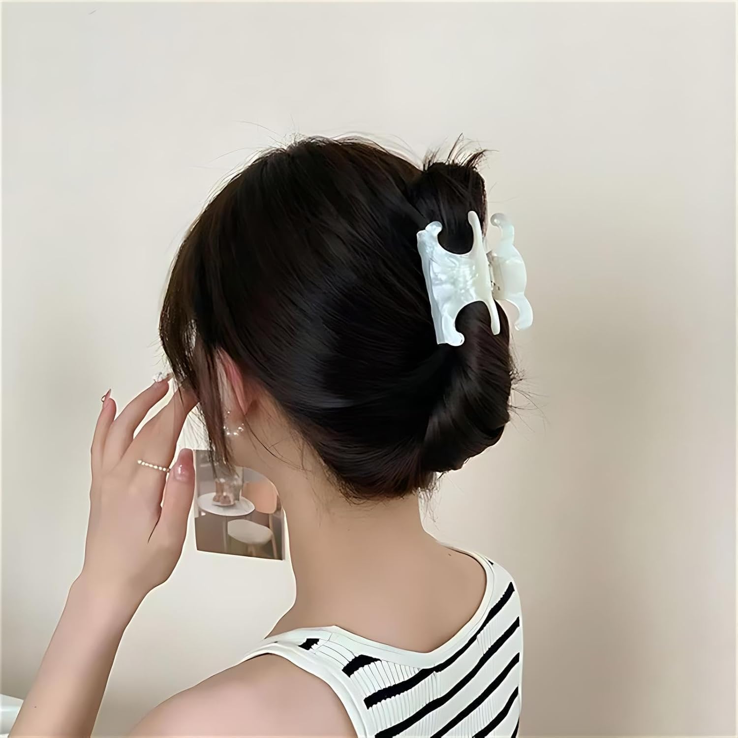 Acetate butterfly clip in tortoiseshell brown coordinates with neutral outfits