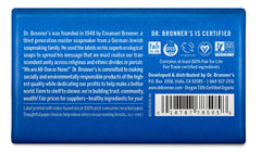 Dr. Bronner's jabón en barra de menta junto a envase reciclado, opción sostenible.