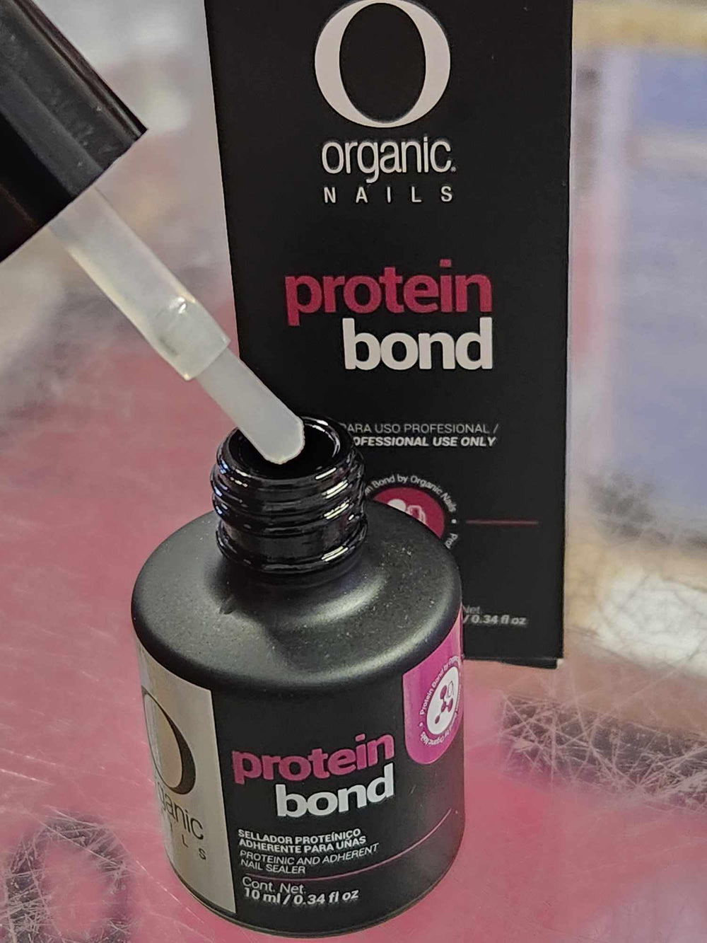 Hands apply Extravaganza Nails primer for prep before color.