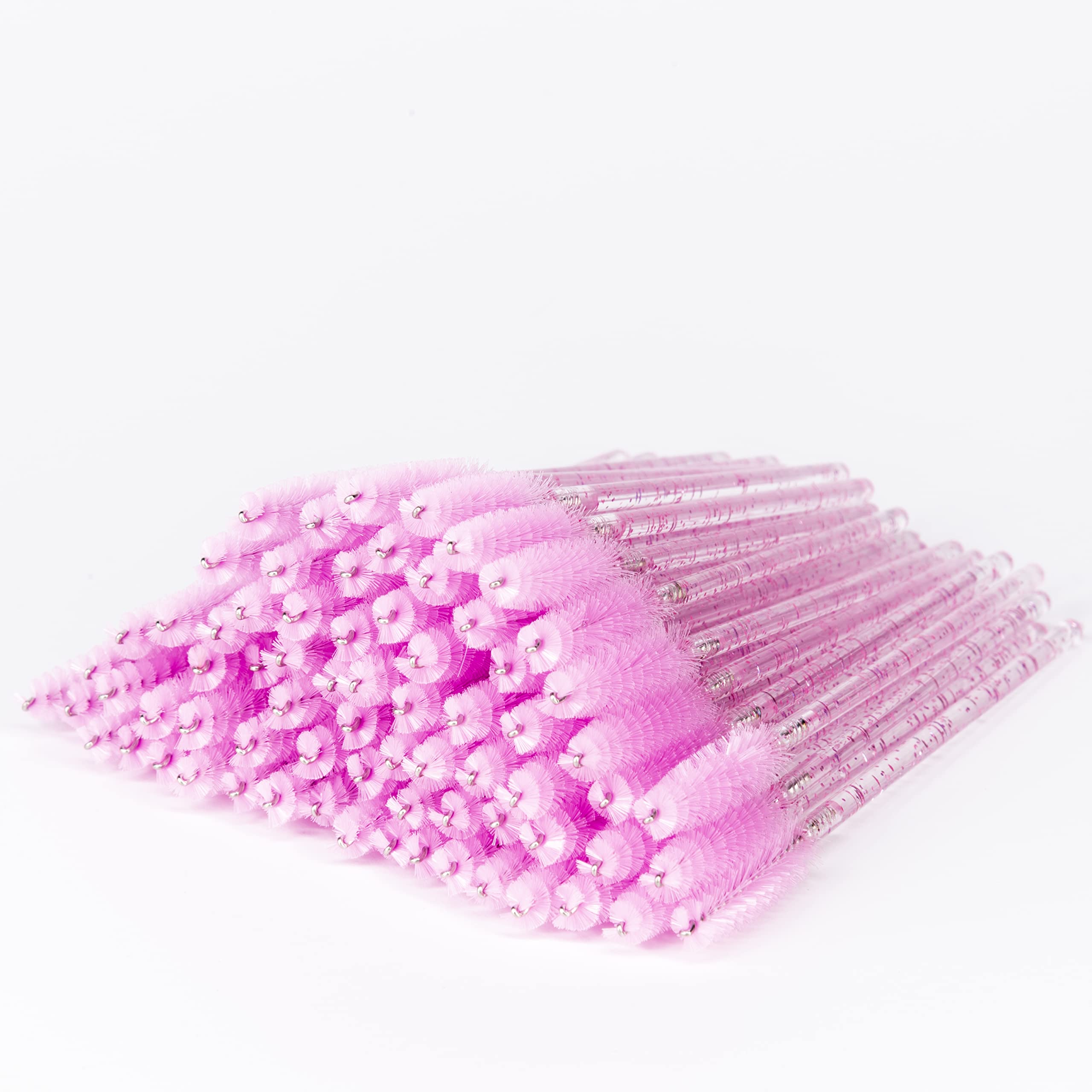 Cepillo i-Laesh con mango cristal rosa para peinar pestañas con precisión.