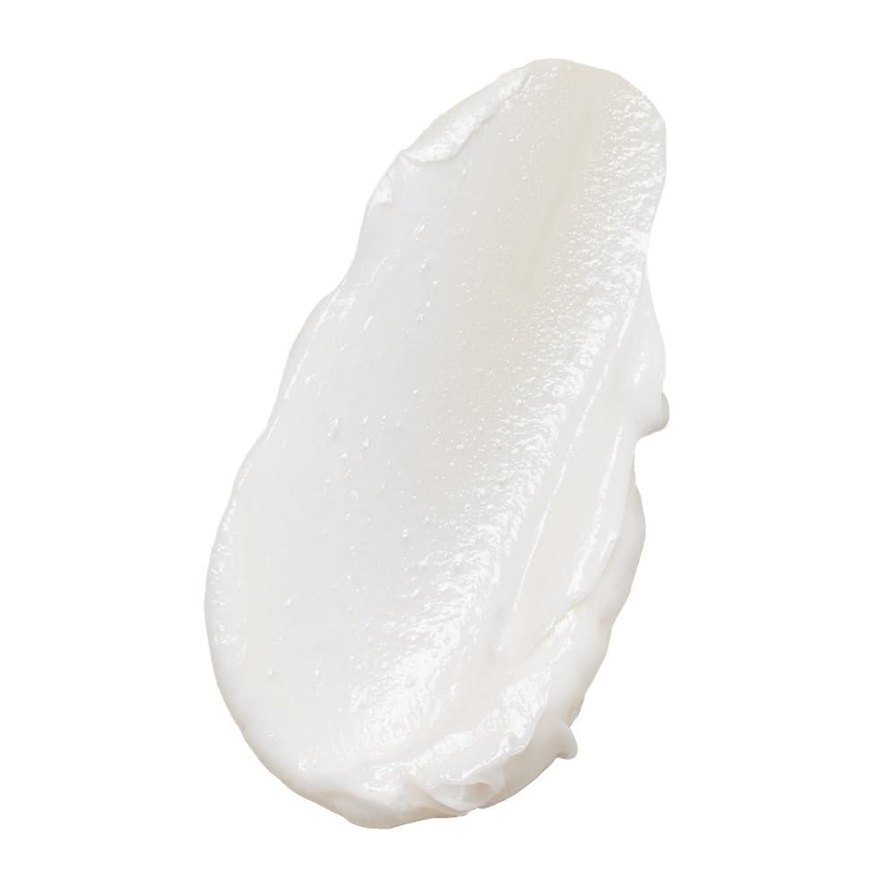 Texture crèmeuse du soin sur les longueurs offre douceur et brillance naturelle.