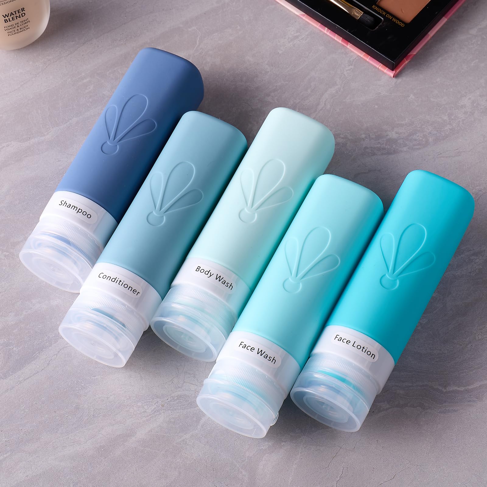 Botellas reutilizables INSFIT con dispensadores flexibles para cosméticos.