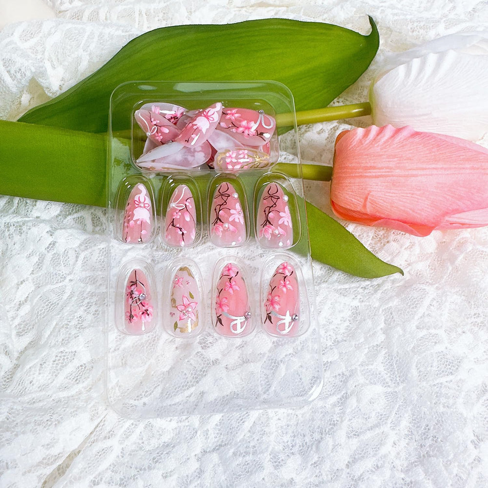 NZRAESTRS uñas almendra rosa con diseño floral y brillo duradero.
