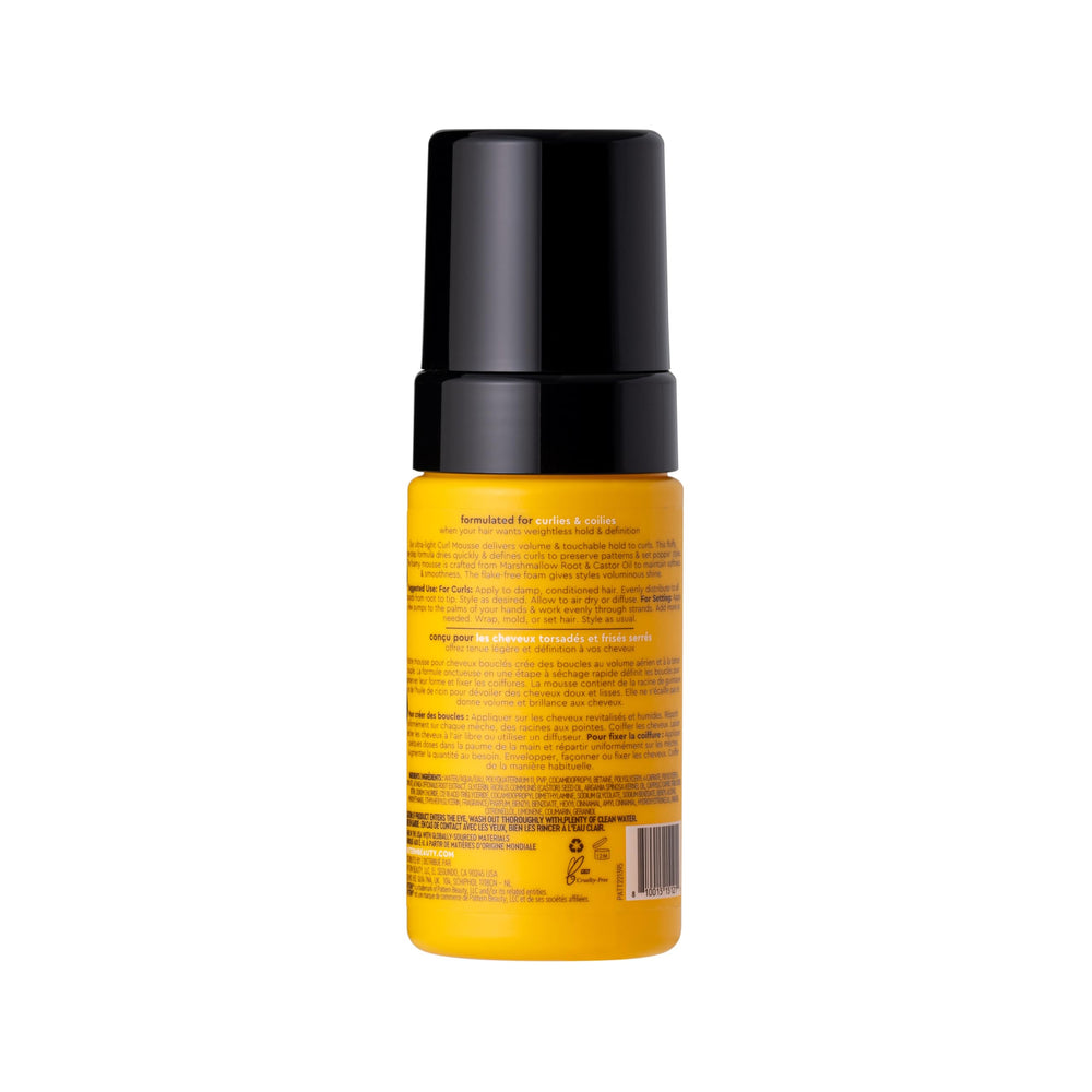 Close-up PATTERN mousse defines curls with shine and movement.