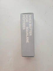 Rhode Barrier Restore Cream in hand during gentle application.