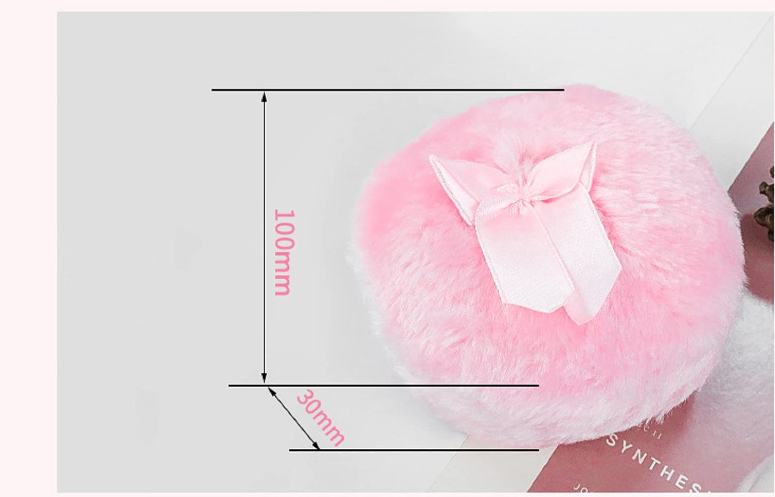 Shuiniba puff con detalle de lazo rosa, mango cómodo para control preciso.