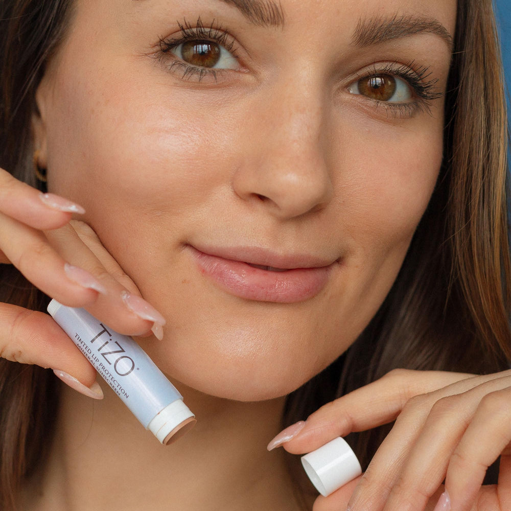 Applying TiZO Lip Protection provides mineral UV defense with smooth lip feel.